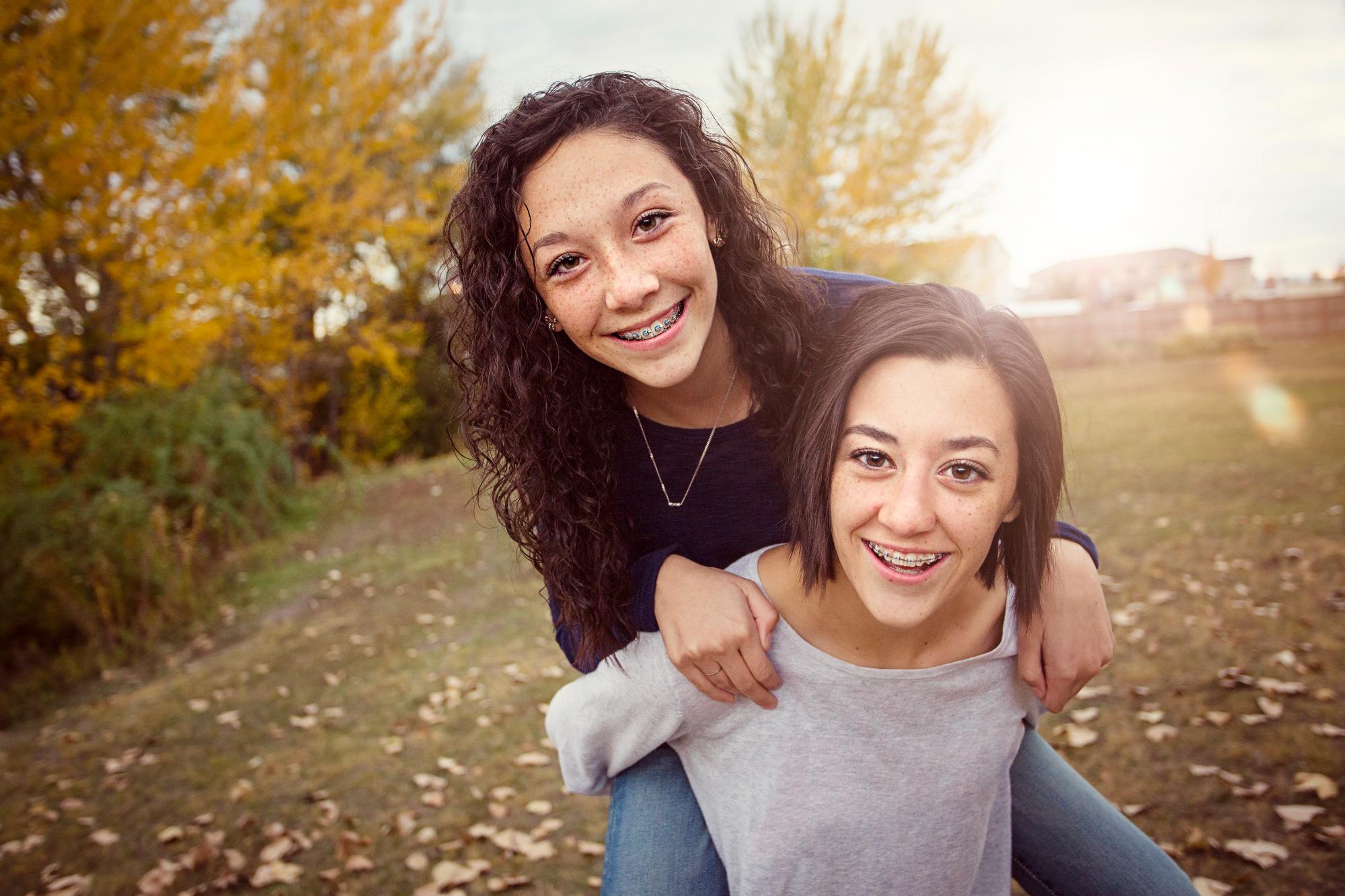Teen smiling with straight teeth after orthodontic treatment at Noyce Orthodontics in St. Joseph and Maryville, MO